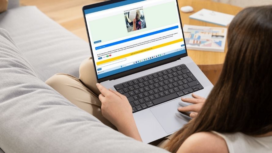 Woman sitting on her sofa with a laptop that shows SuperNova Ask AI describing an image of a child playing